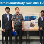 TIA Students standing with their project display board and faculty member.